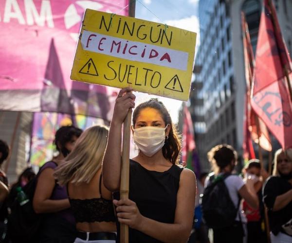 woman with signboard at femicide protest 